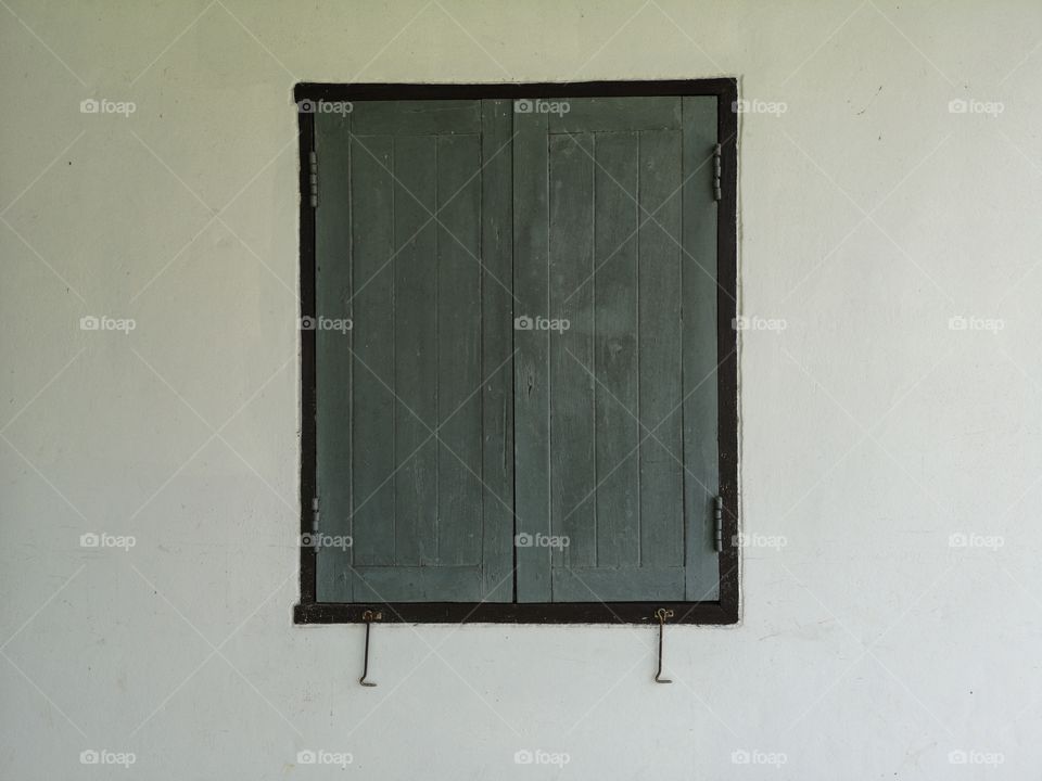 Wooden windows with white walls.