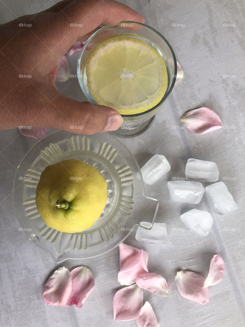 Making lemon drink with ice in the summer flat lay