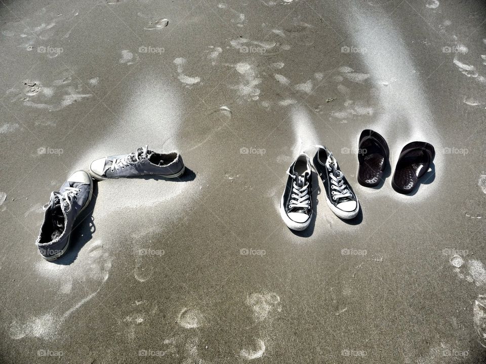 Sandy shoes. Throw away your shoes on a beautiful beach and see them disapearing very slowy because of soft sand drifts.