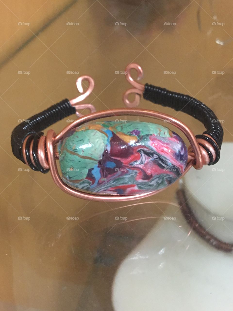 A clay bead hand made by me along with great wire work to connect it all together. 