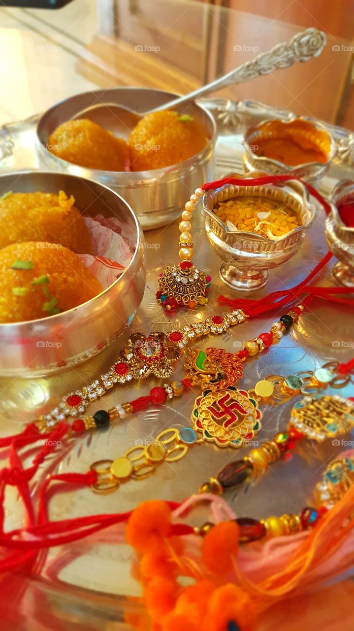 #rakhee #tradition #indiantradition #silver #silverbowl #sweet #orangesweet #jewellery #beeds #luxury #stilllife #indoor #traditional
