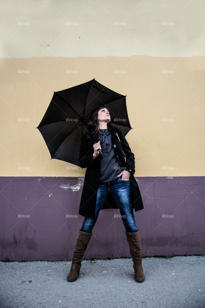 Young woman holding umbrella