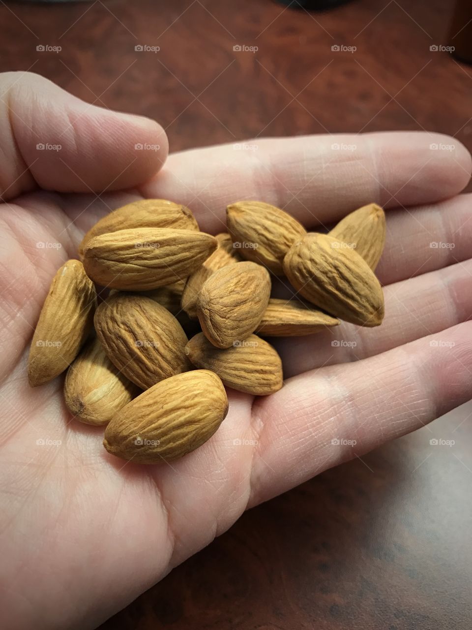 Almonds on person's hand