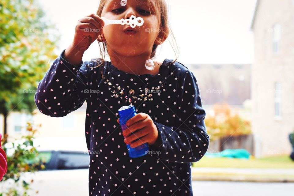 Kid blowing bubbles 