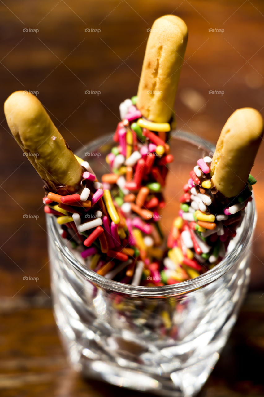 biscuit stick coated with chocolate flavor and rainbow sugar of topping.