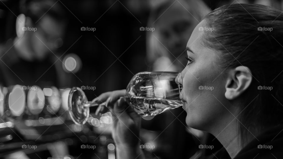 Young woman drinking prosecco at a puv