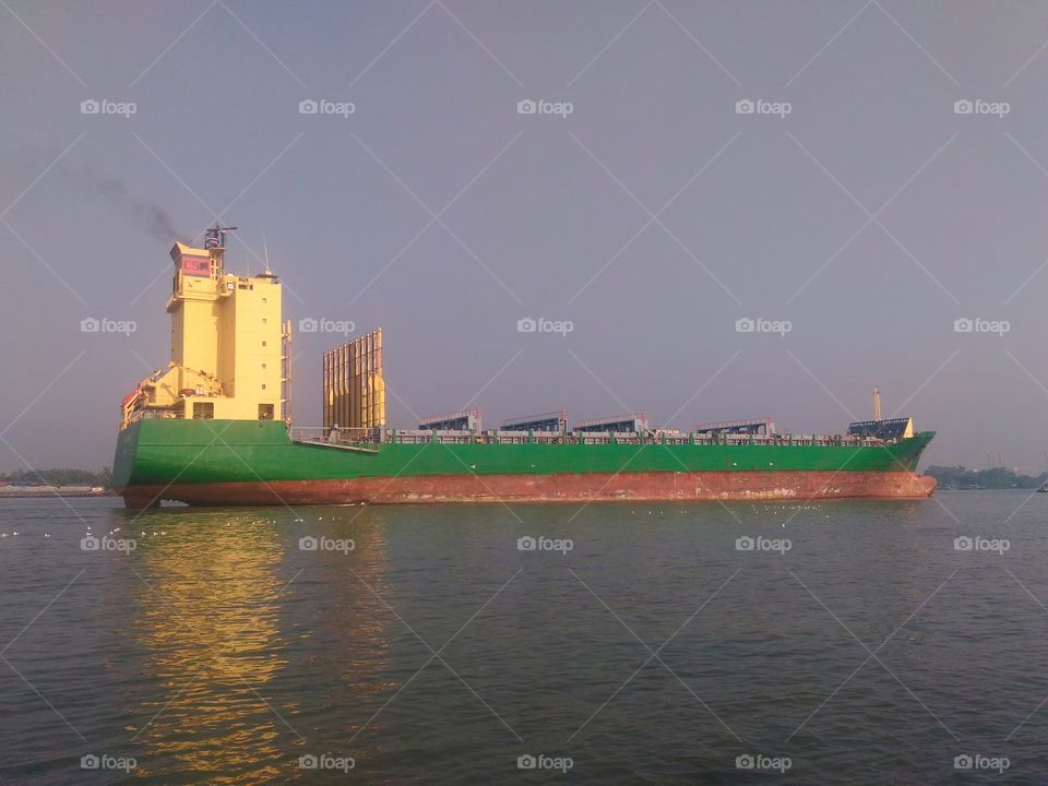 green cargo ship in  chaopraya river bangkok thailand