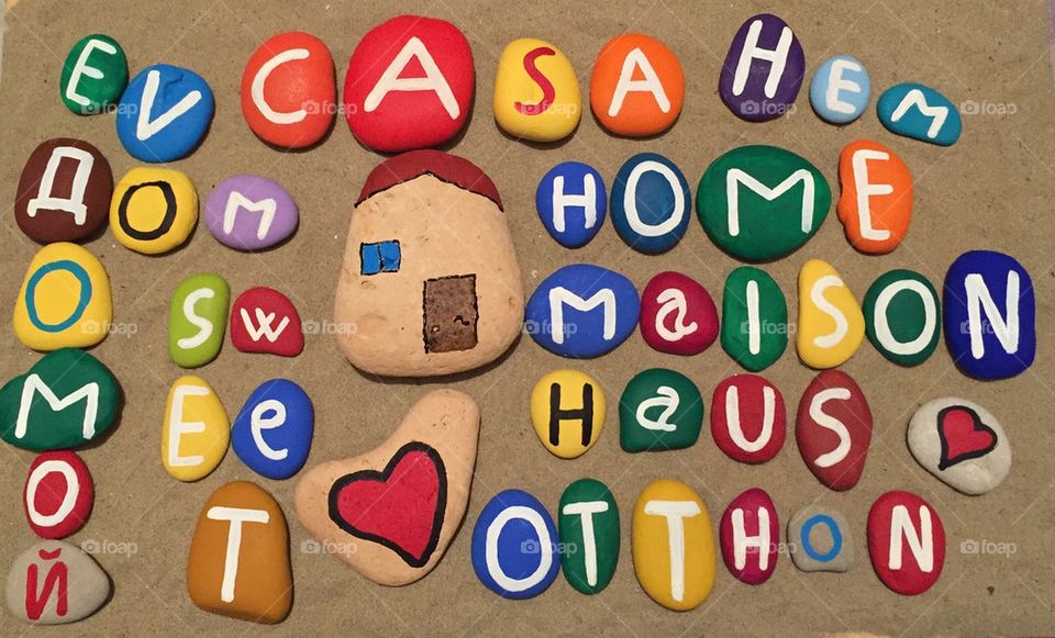 Home sweet home in many languages on stones