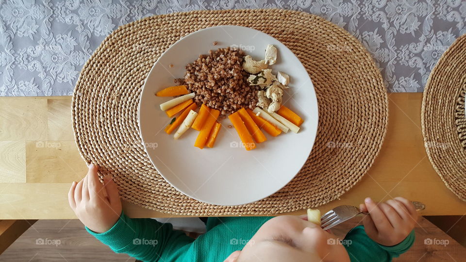 Child eating diner at home