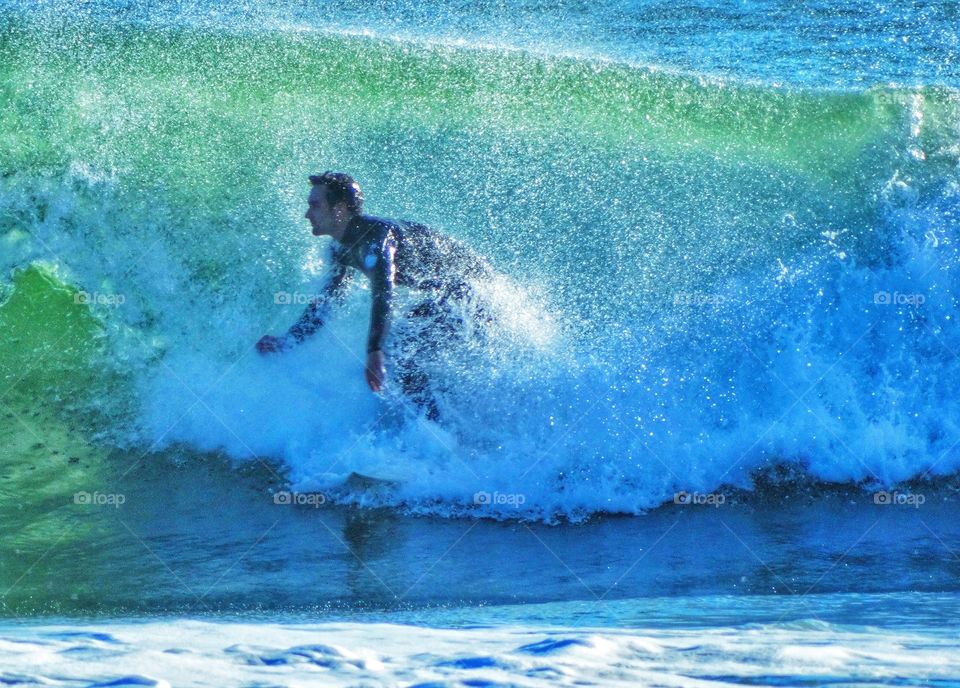 Surfer riding the waves at Año Nuevo Beach in Northern California
