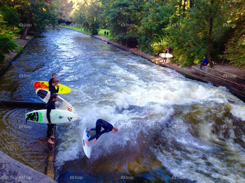 Young Surfers enjoy River Rapids in Munich, Germany