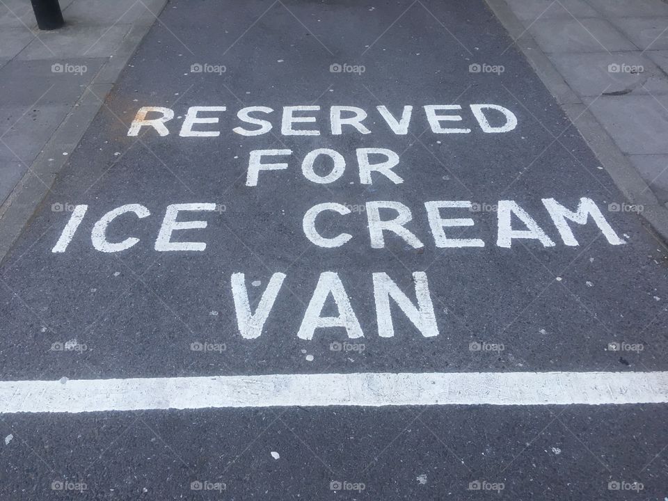 Parking space reserved for ice cream van at Waterfields Shopping Park, Watford, in Spring.