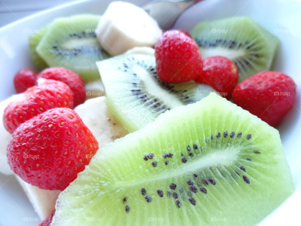 Healthy fruits breakfast full of vitamins with strawberry, kiwi,  and banana