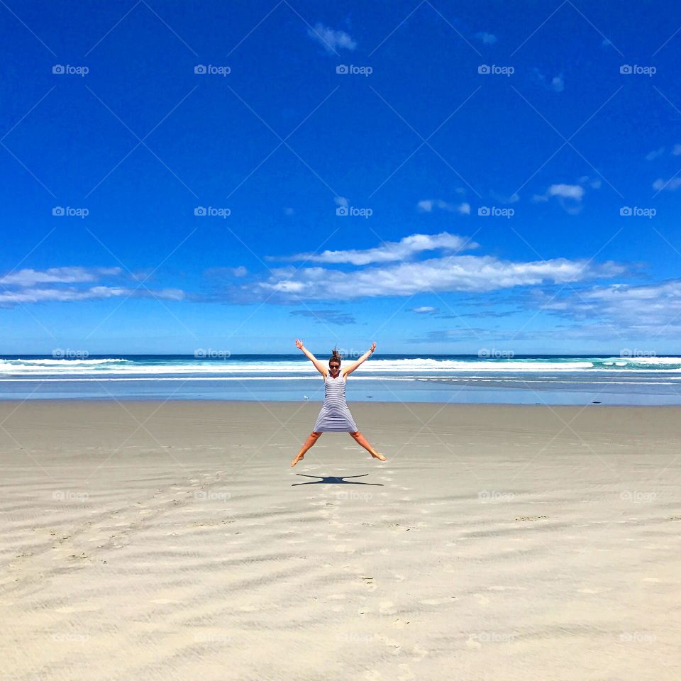 Girl jumping on beach 