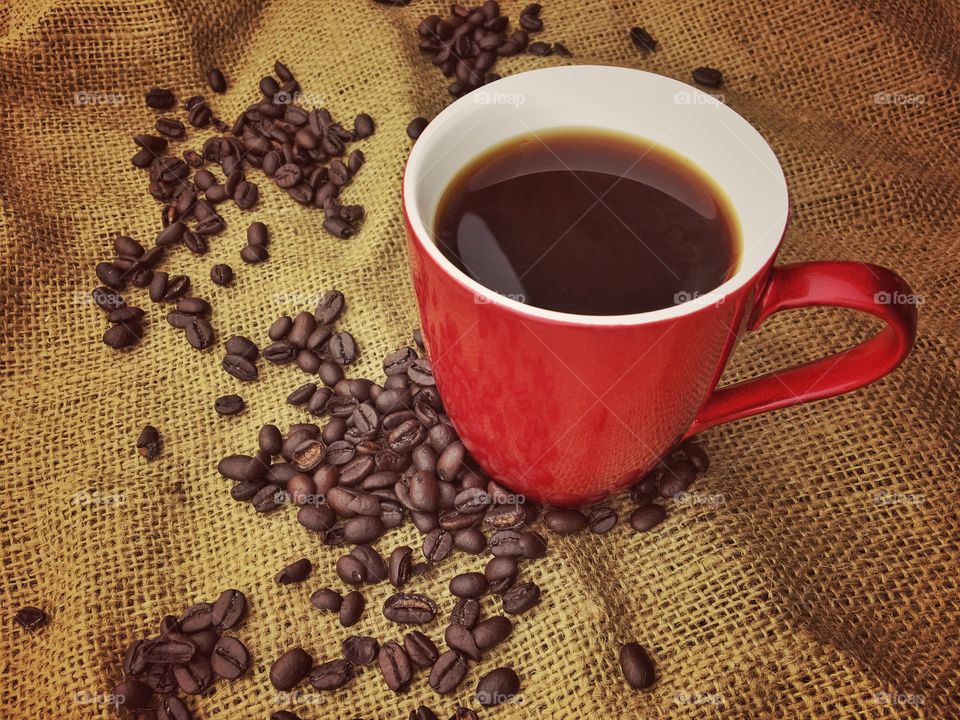 Cup of coffee with coffee beans