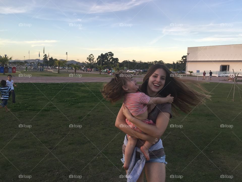Close-up of a happy mother carrying her daughter