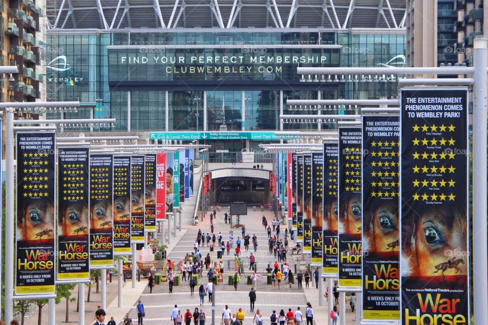 Crowd at Wembley Stadium between advertising flags