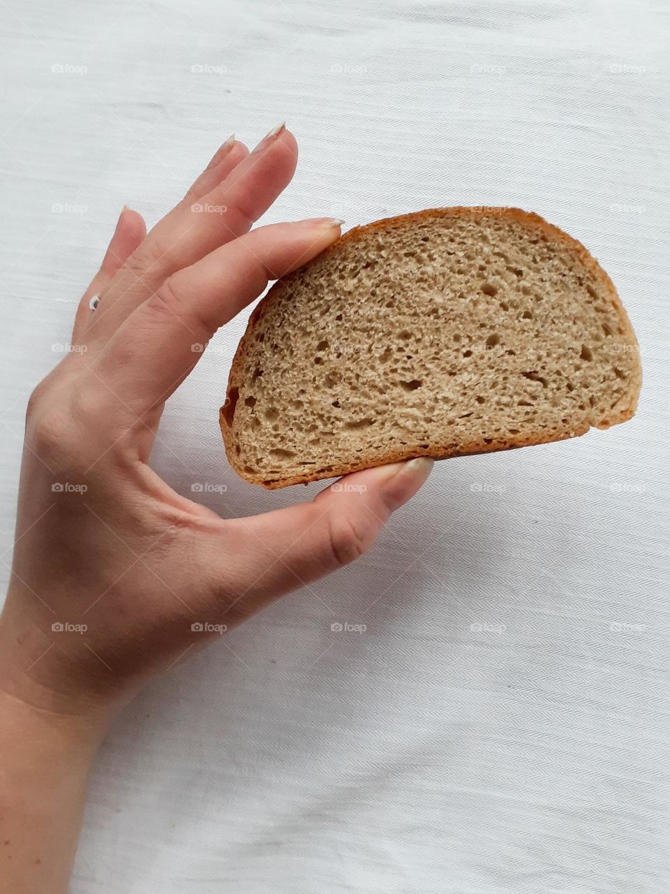 Piece of bread in hands