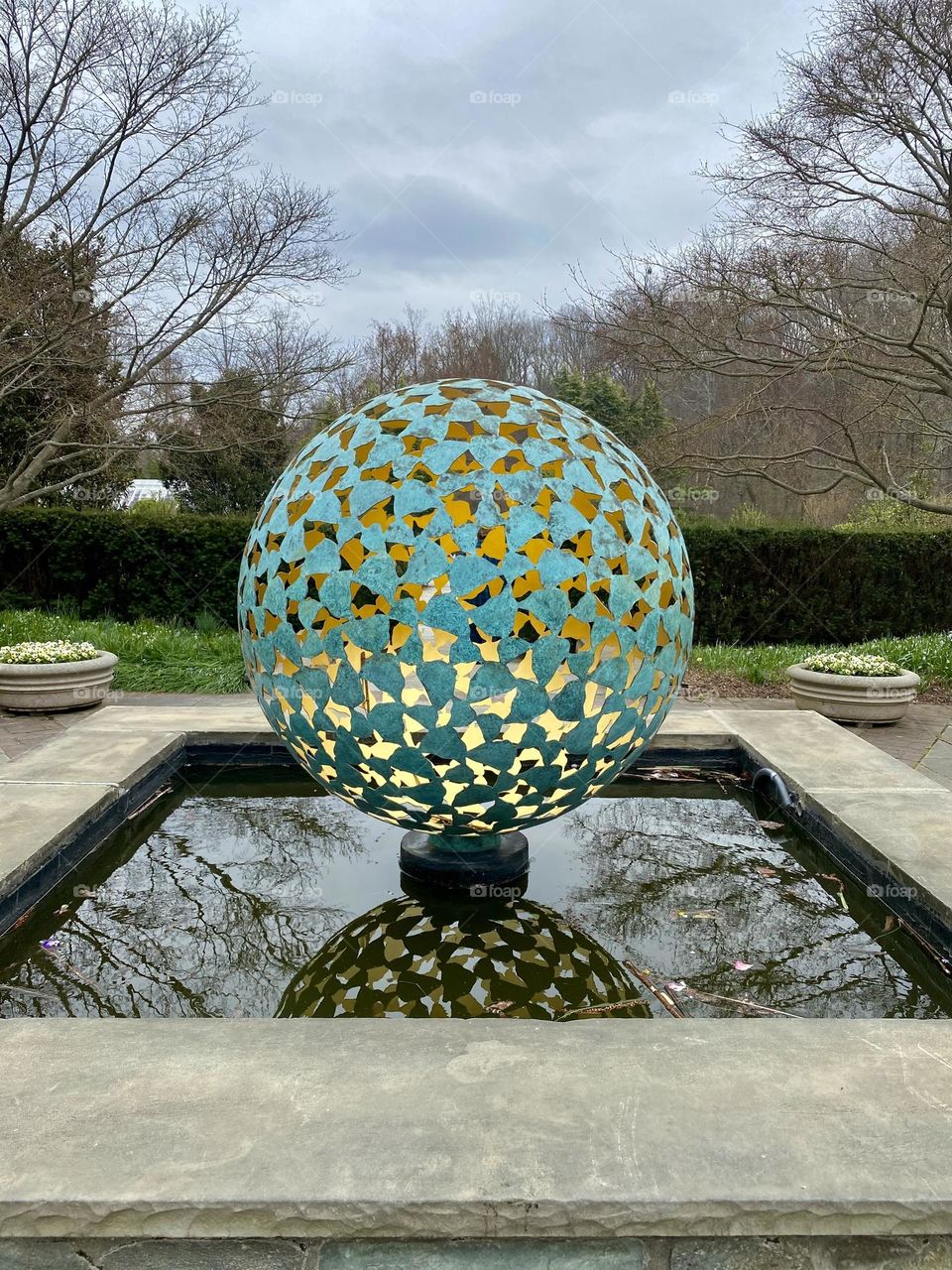 A sculpture in a pond at a local garden