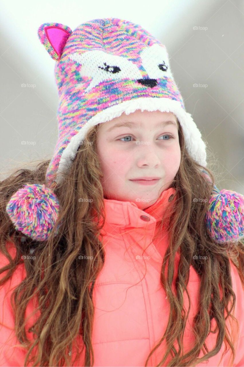 Girl with long hair wearing woolly hat