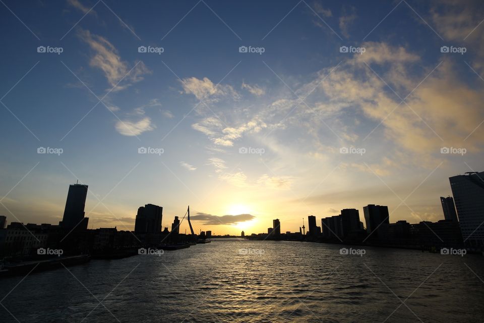 Rotterdam cityscape view towards the erasmusbrug during sunset in silhouette style