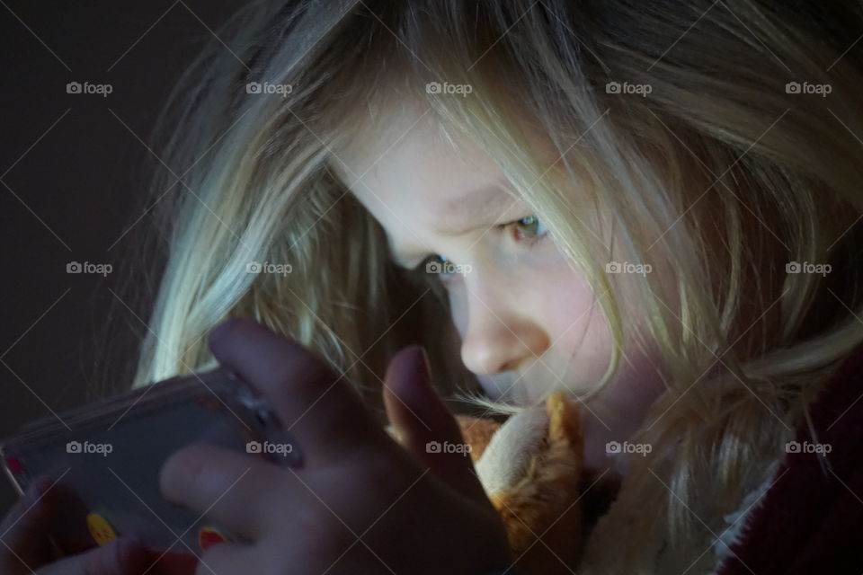 Close-up of a girl using mobile phone