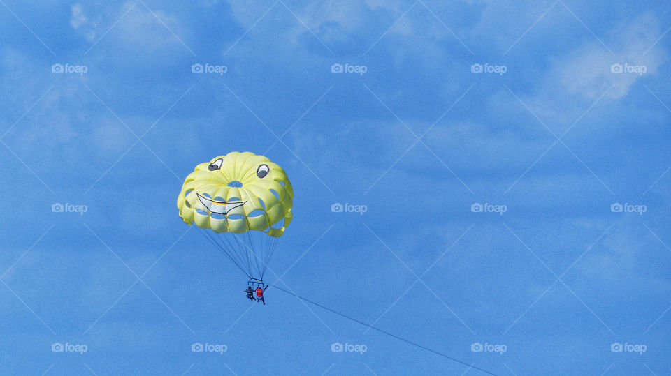 One yellow parasail in the blue sky 