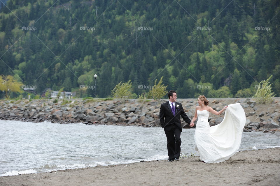 Beautiful couple on the beach in wedding dress