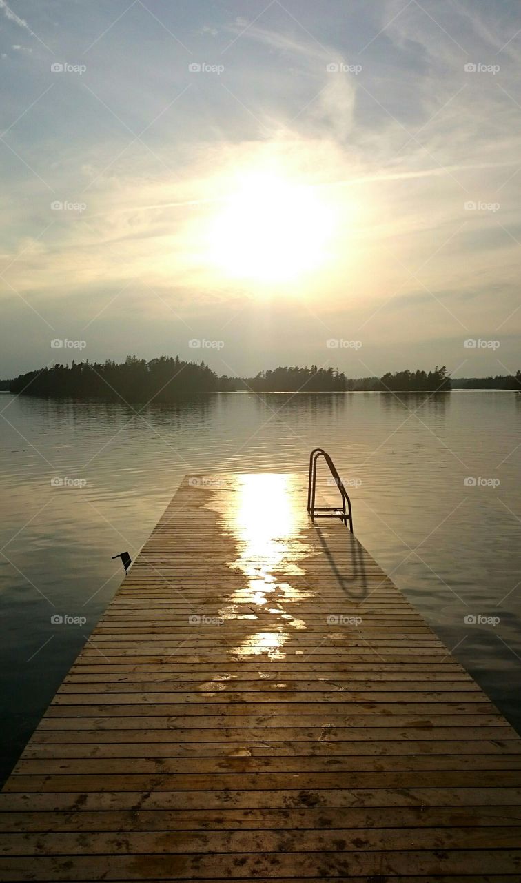 Sun reflection in the water on the jetty