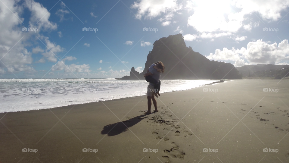 Couple hugging at beach