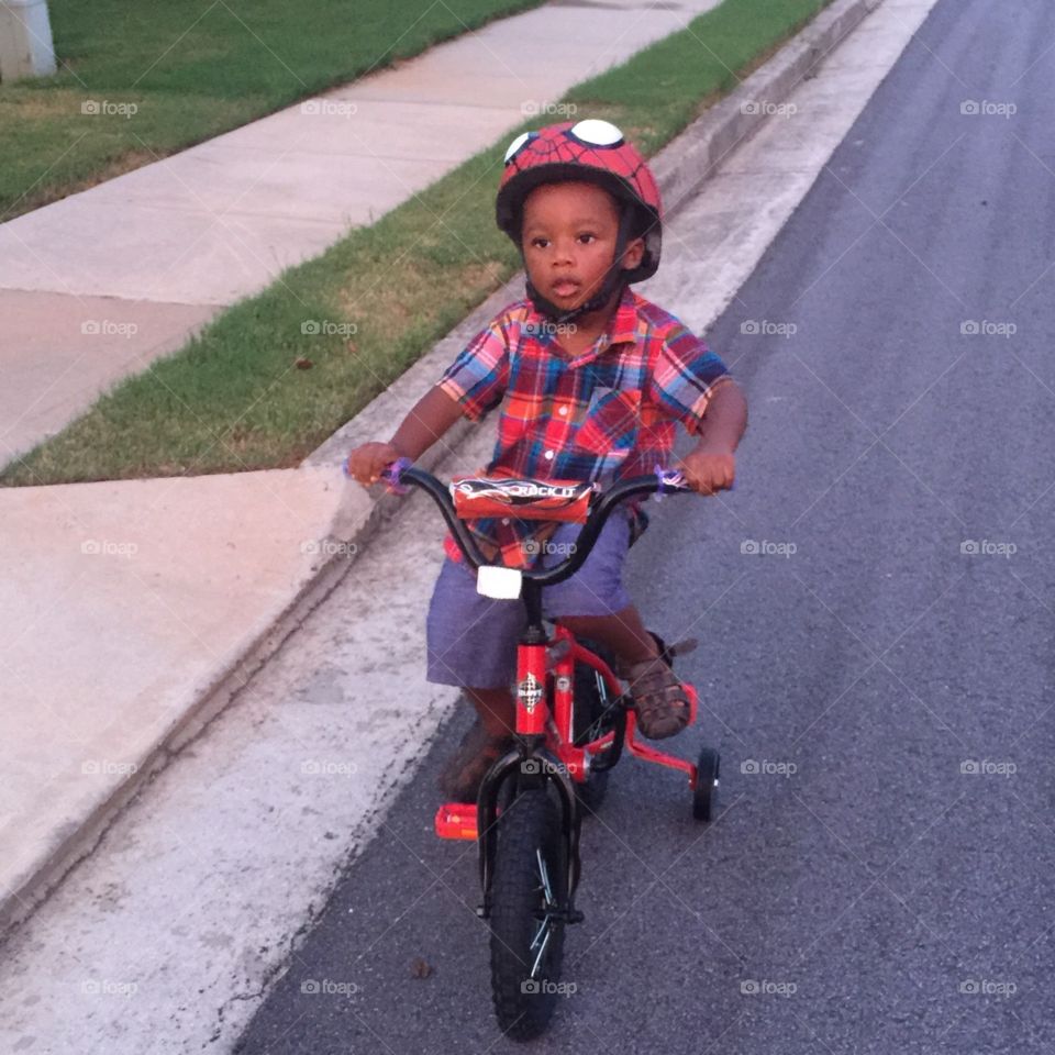 Son riding his bike