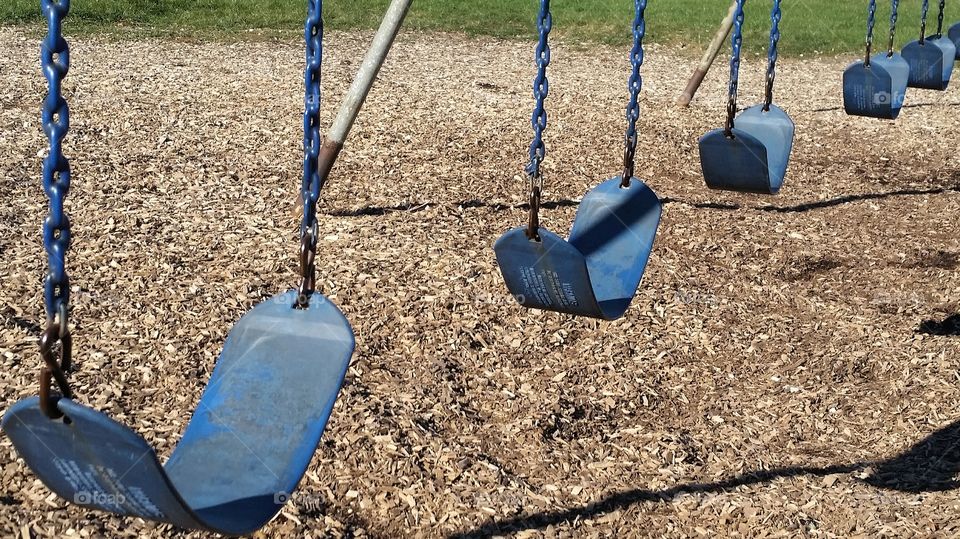 Empty swings on the playground