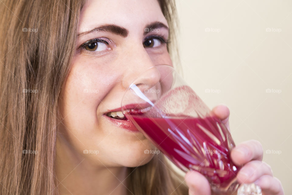 A young woman drinking a smoothie