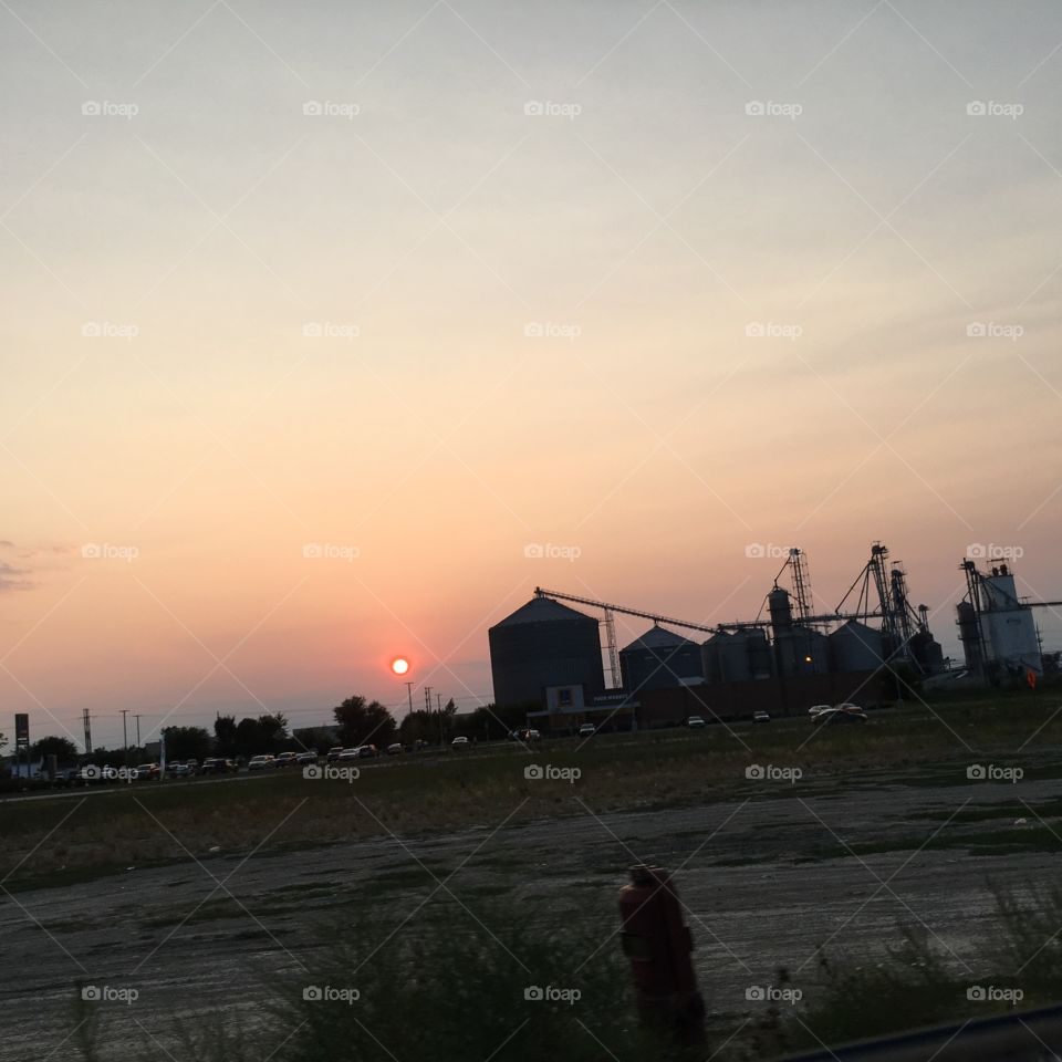 Sun setting highlights silo silhouette 
