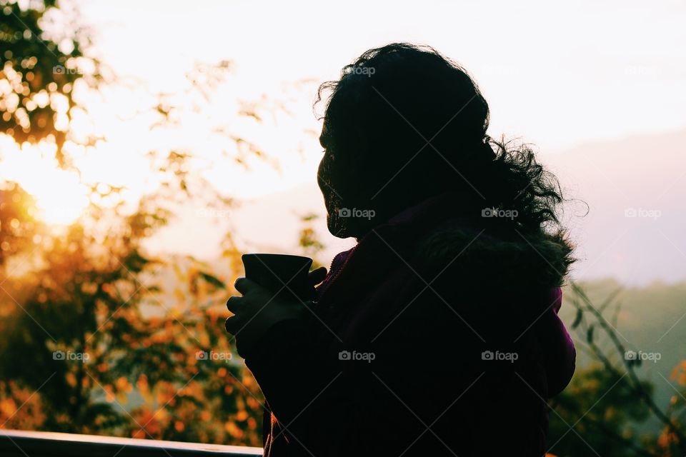 Morning person - amazing silhouette - woman having coffee in winter