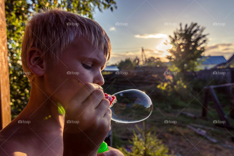 boy making bubbles