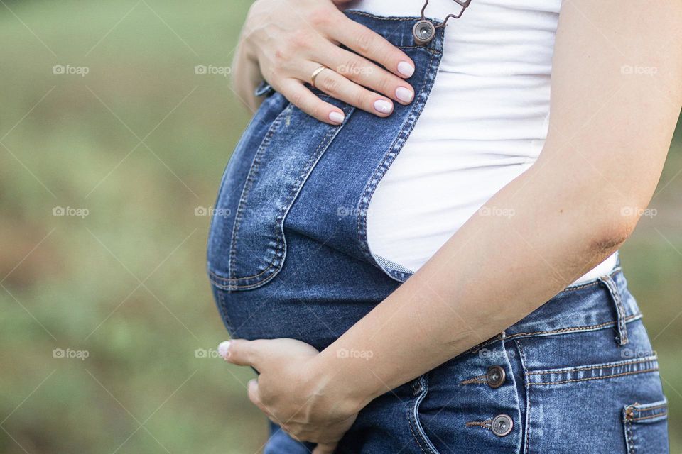 pregnant woman stroking her tummy