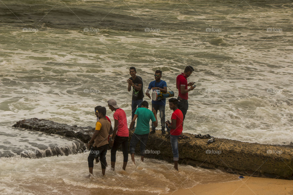 Youth playing music at beach