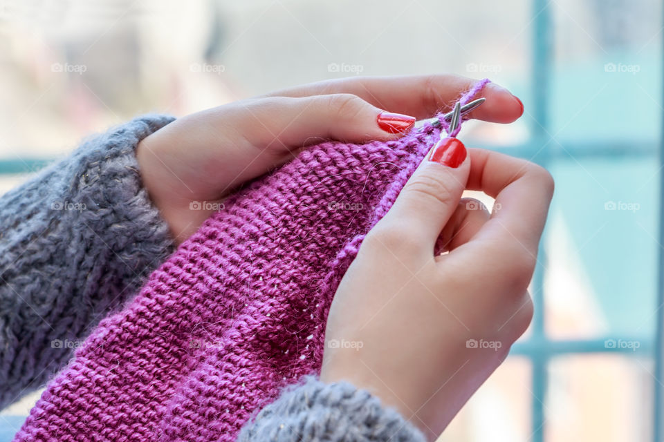 A woman holding knitting