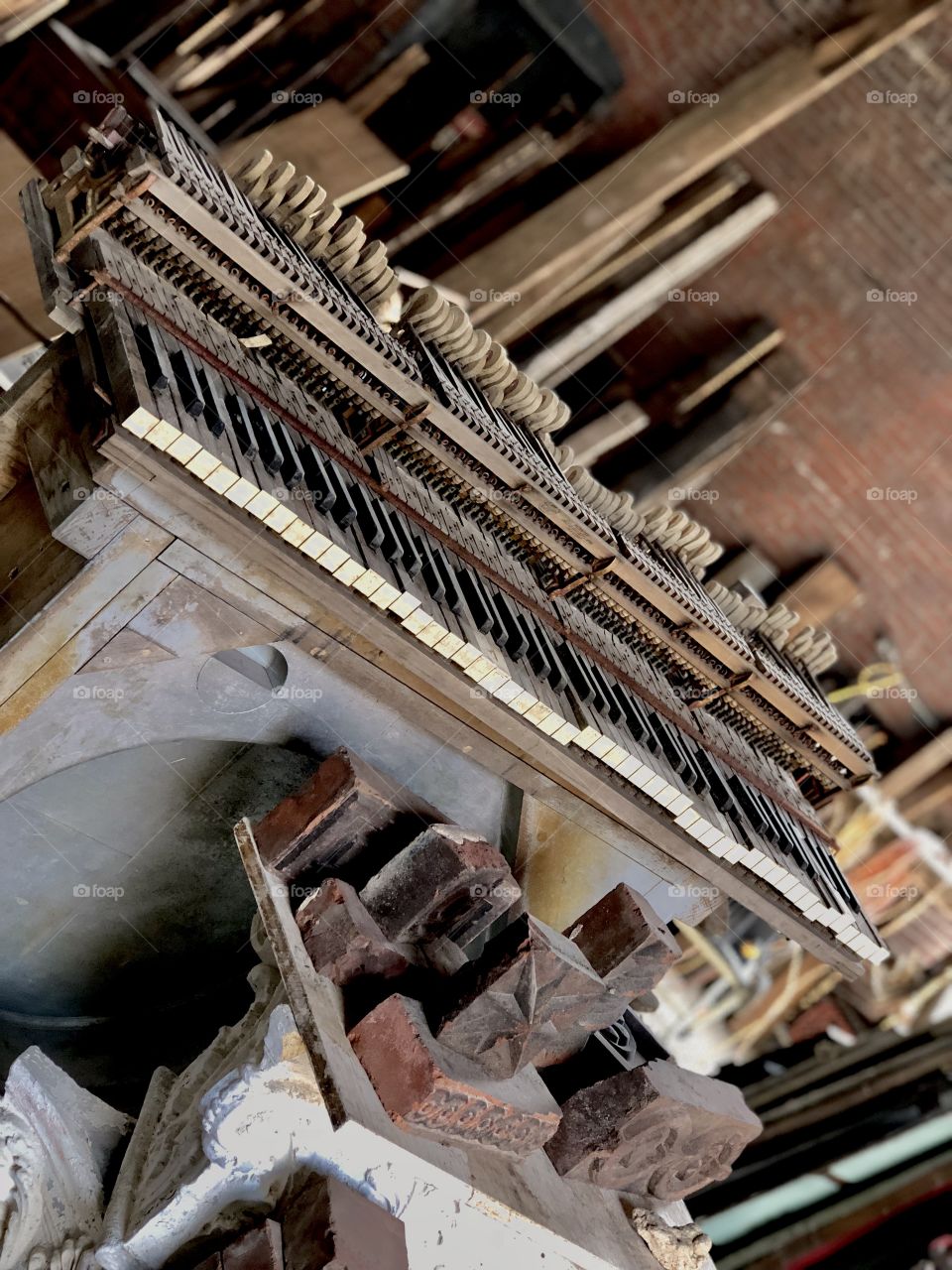 Vintage piano in warehouse full of rescued items from pre-demolished buildings