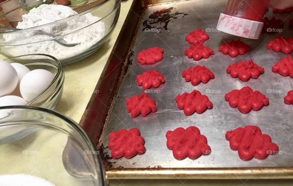 Making red spritz Christmas cookies 
