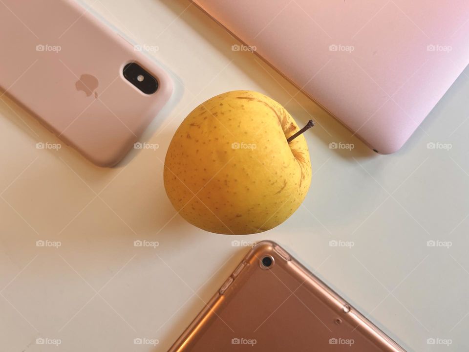 Yellow delicious apple at the center and apple products 