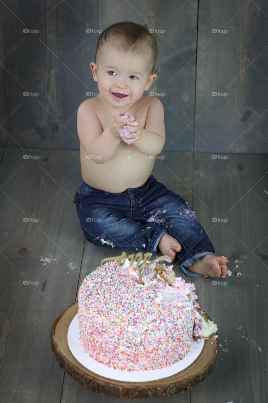 Cute boy devouring birthday cake