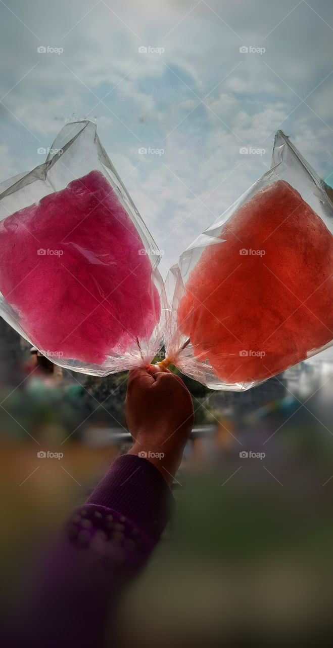 In this photo I captured a colorful sugar cotton candy it looks so colorful and very delicious. I captured two sugar cotton candy comparing with sky, It's looks so yummy