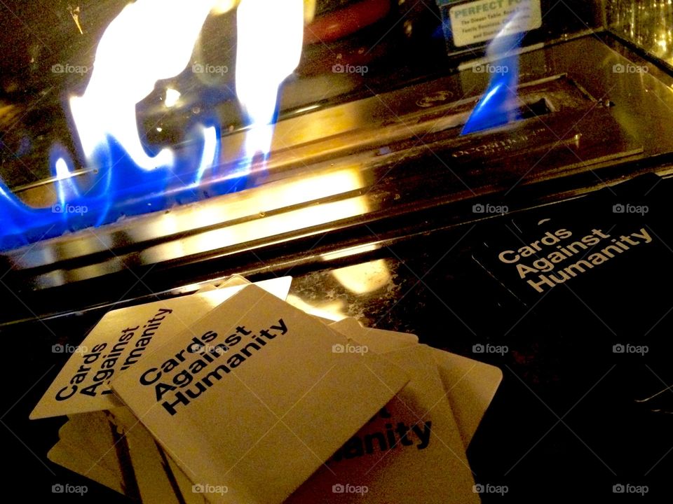 A flame and cards against humanity game cards