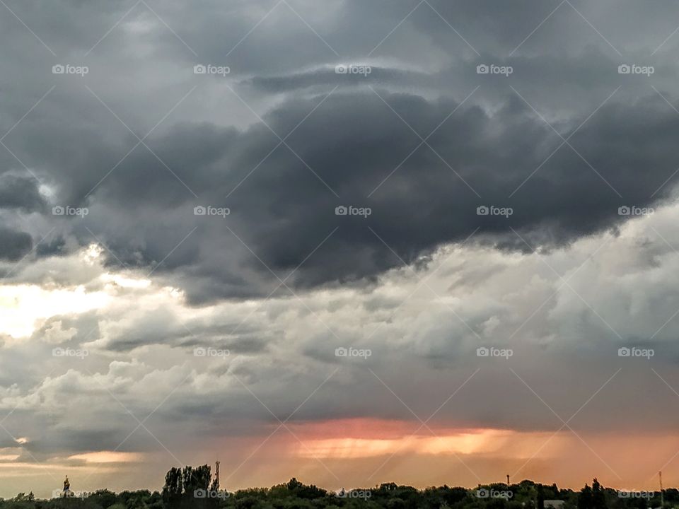 Dark grey clouds and the lines of rain