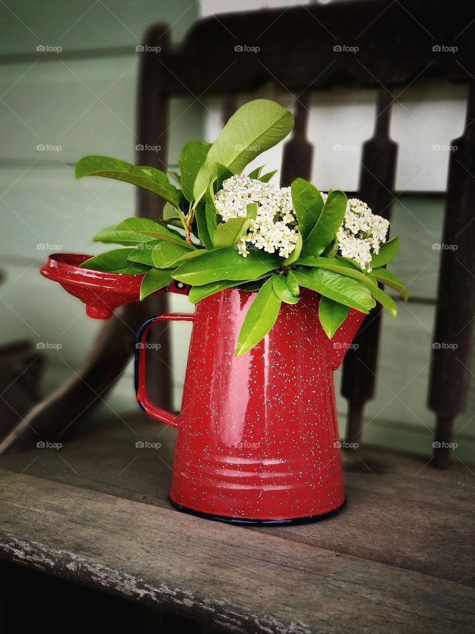 Campfire Coffee Pot on a Bench Outside with flowers