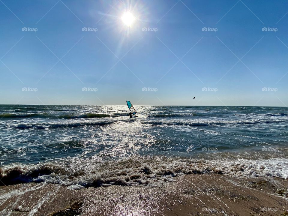 Windsurfer at sea on the waves.