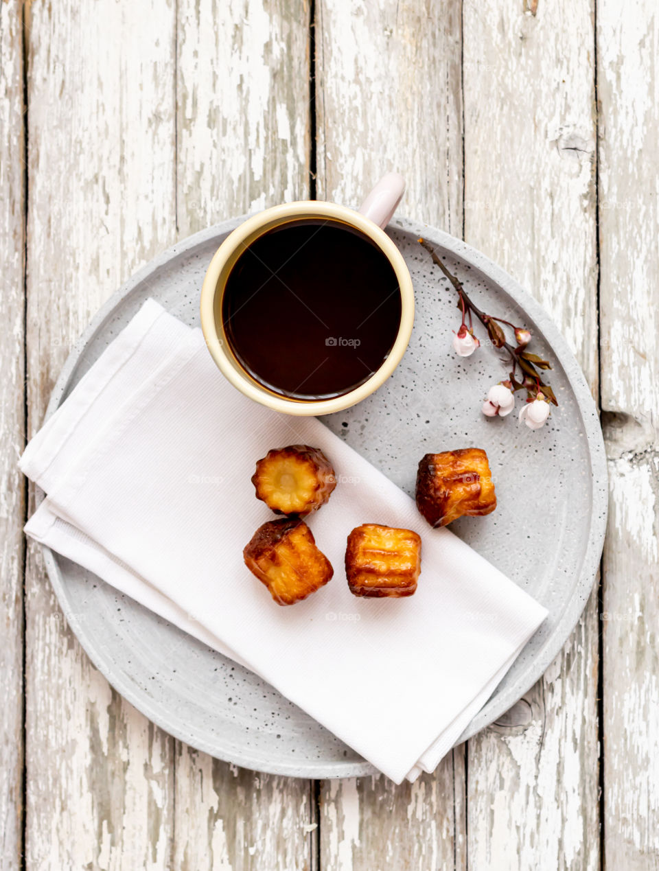 Top view to mug with black coffee and some pastry.