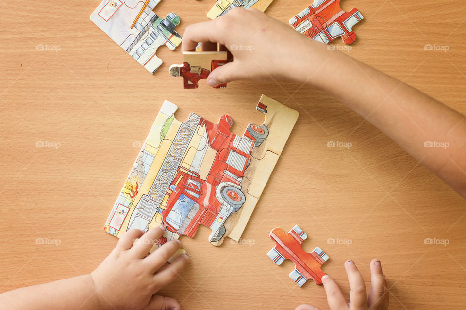 Children playing jigsaw puzzle